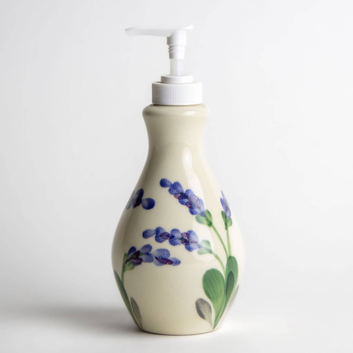 Stoneware refillable soap or lotion bottle with a white pump top. Hand painted lavender flowers on the sides. Creamy white color. Zero waste home.