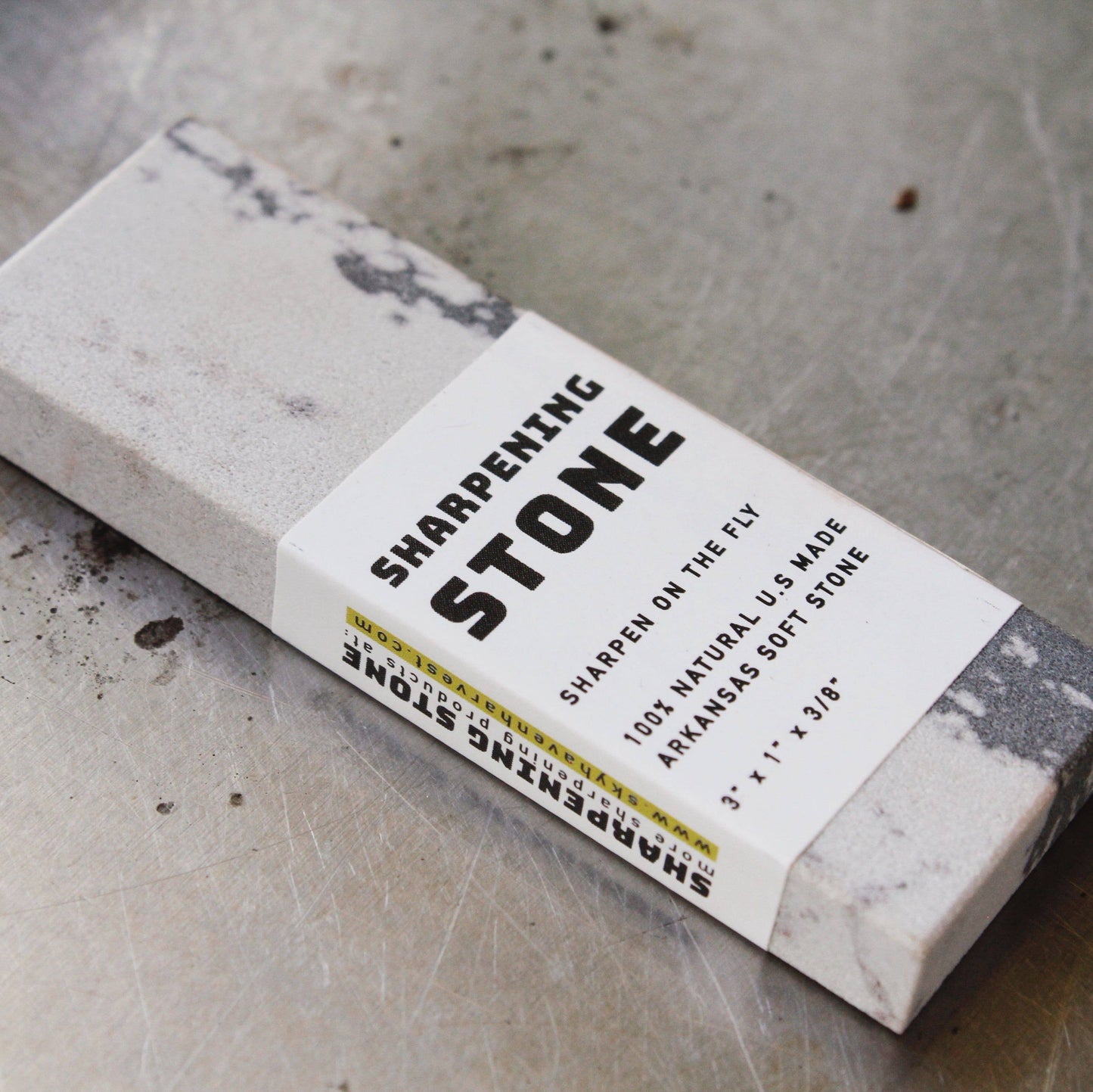 Small sharpening stone for garden tools and knives. White with gray marbling pocket sized USA made sharpener.