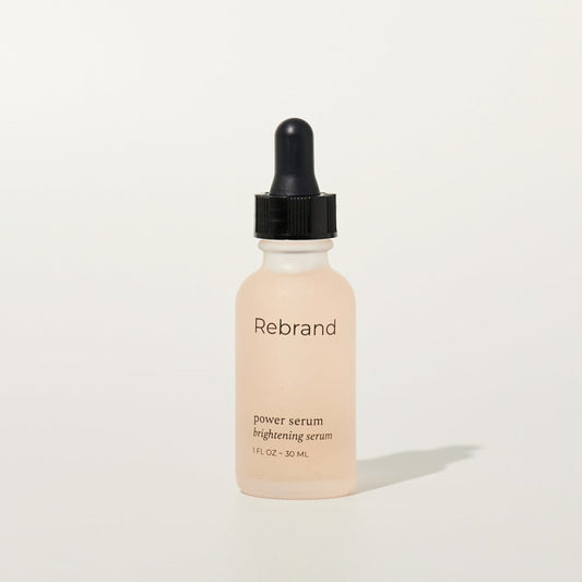 Power Serum by Rebrand skincare, brightening face serum in a frosted glass bottle with black dropper lid. 1 fl oz. earth friendly zero waste refillable eco conscious skincare