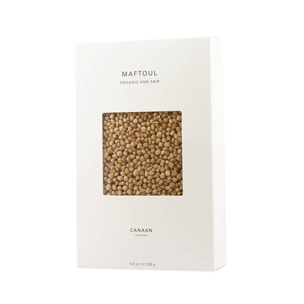 Maftoul by Canaan Palestine in a white paper box with a window on front. Palestinian cous cous.