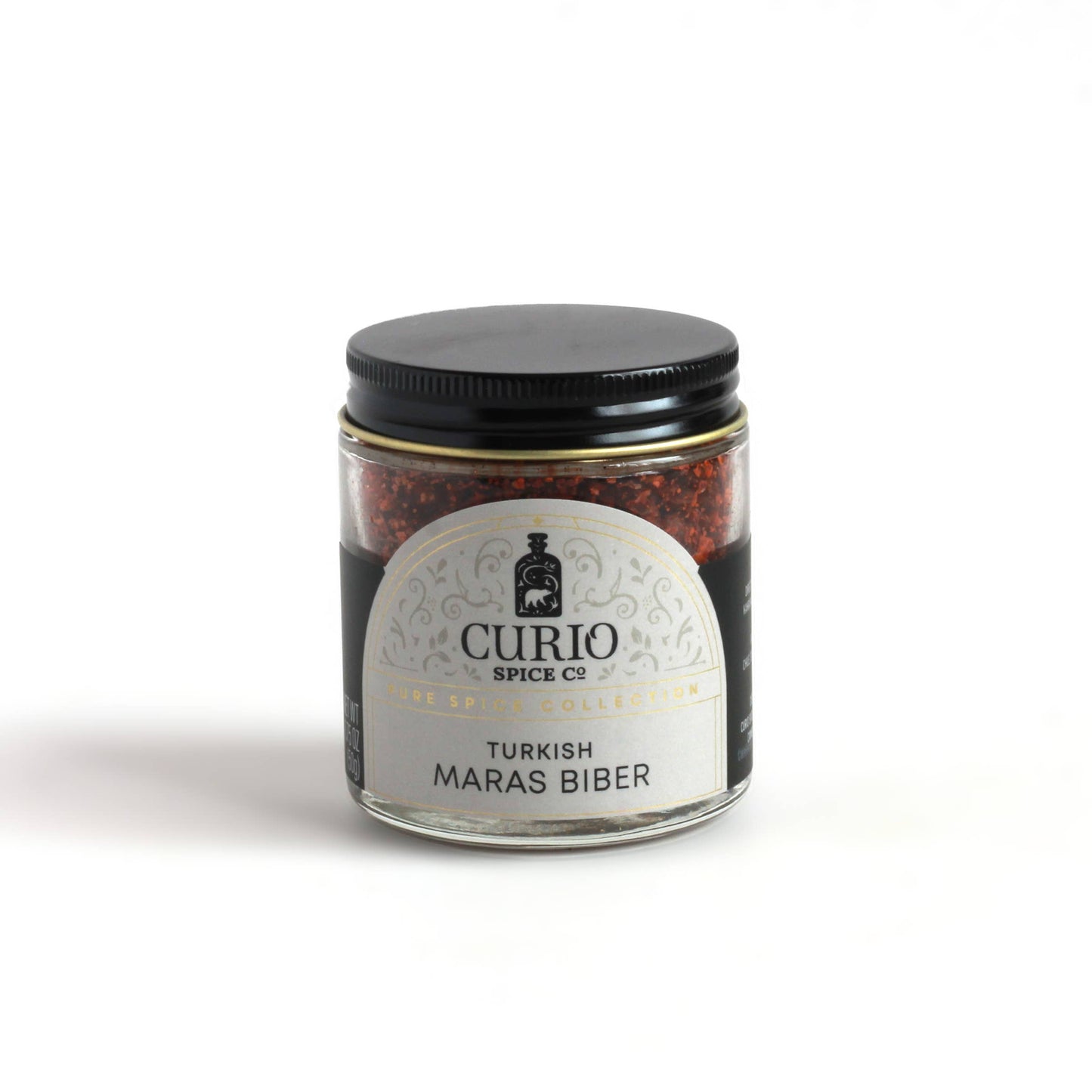 Turkish Maras Biber by Curio Spice Co in a glass jar. Red chili flakes spice. 