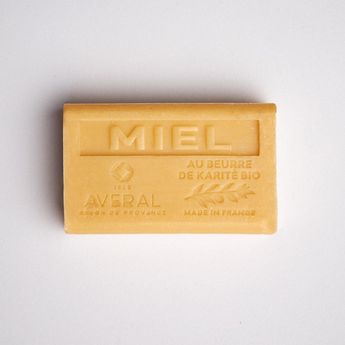 Golden yellow bar of soap. Stamped with Miel, au beurre de karite bio, made in france, averal savon de provence on the front. Gentle honey french bar of soap. 