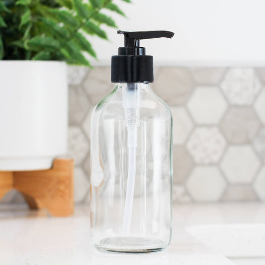 9 ounce clear glass bottle with a black pump top. empty and refillable perfect for zero waste home