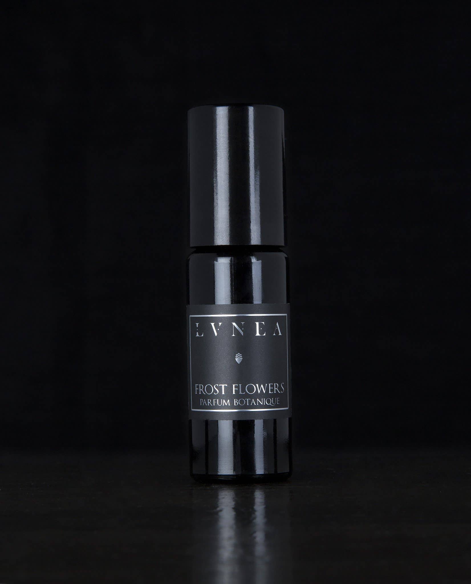 Frost Flowers Lvnea perfume. Black glass rollerball bottle. tuberose · jasmine · black currant · ambrette · cypress · elemi resin