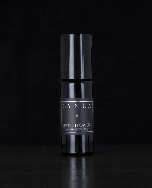 Frost Flowers Lvnea perfume. Black glass rollerball bottle. tuberose · jasmine · black currant · ambrette · cypress · elemi resin