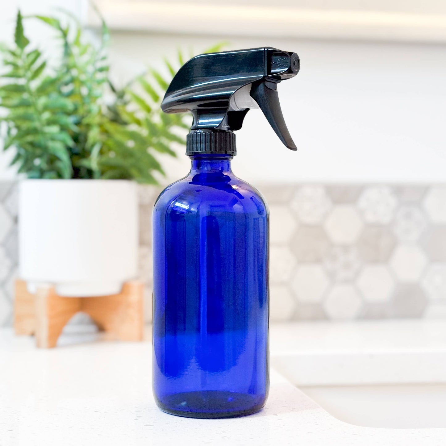 Cobalt blue glass bottle with a black spray nozzle. 16 oz bottle. Zero waste home