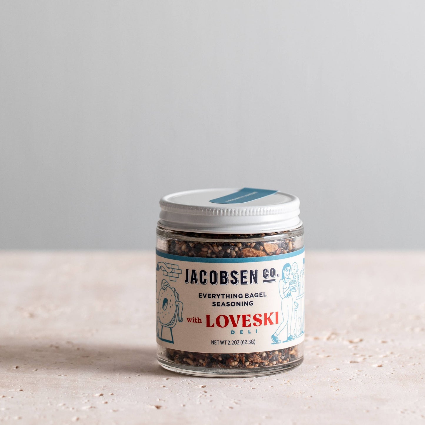 Everything bagel seasoning in a glass jar with  Jacobsen Co  branded label