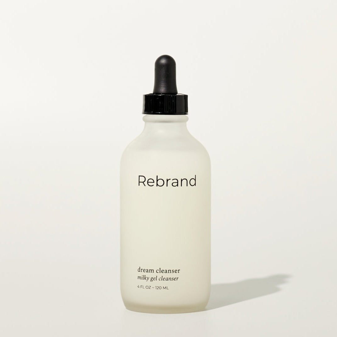 Dream cleanser by Rebrand skincare, milky gel cleanser in a frosted glass bottle with black dropper lid. 4 fl oz. earth friendly zero waste refillable eco conscious skincare