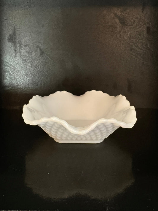 White ceramic foot sculpture on a dark textured surface