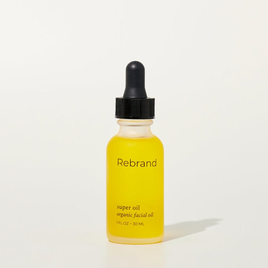 Super Oil by Rebrand skincare, organic facial oil in a frosted glass bottle with black dropper lid. 1 fl oz.  earth friendly zero waste refillable eco conscious skincare