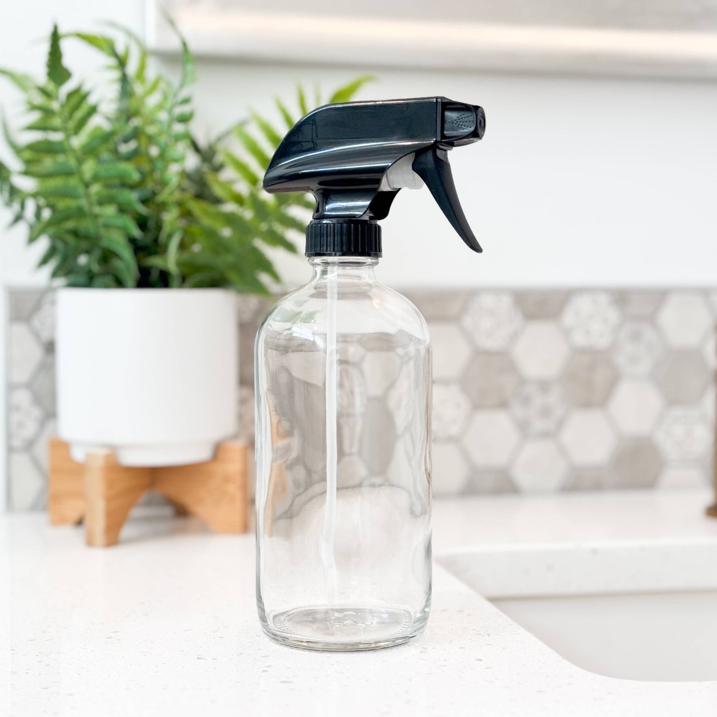 16 oz clear glass bottle with a black spray nozzle. Empty and refillable perfect for zero waste home