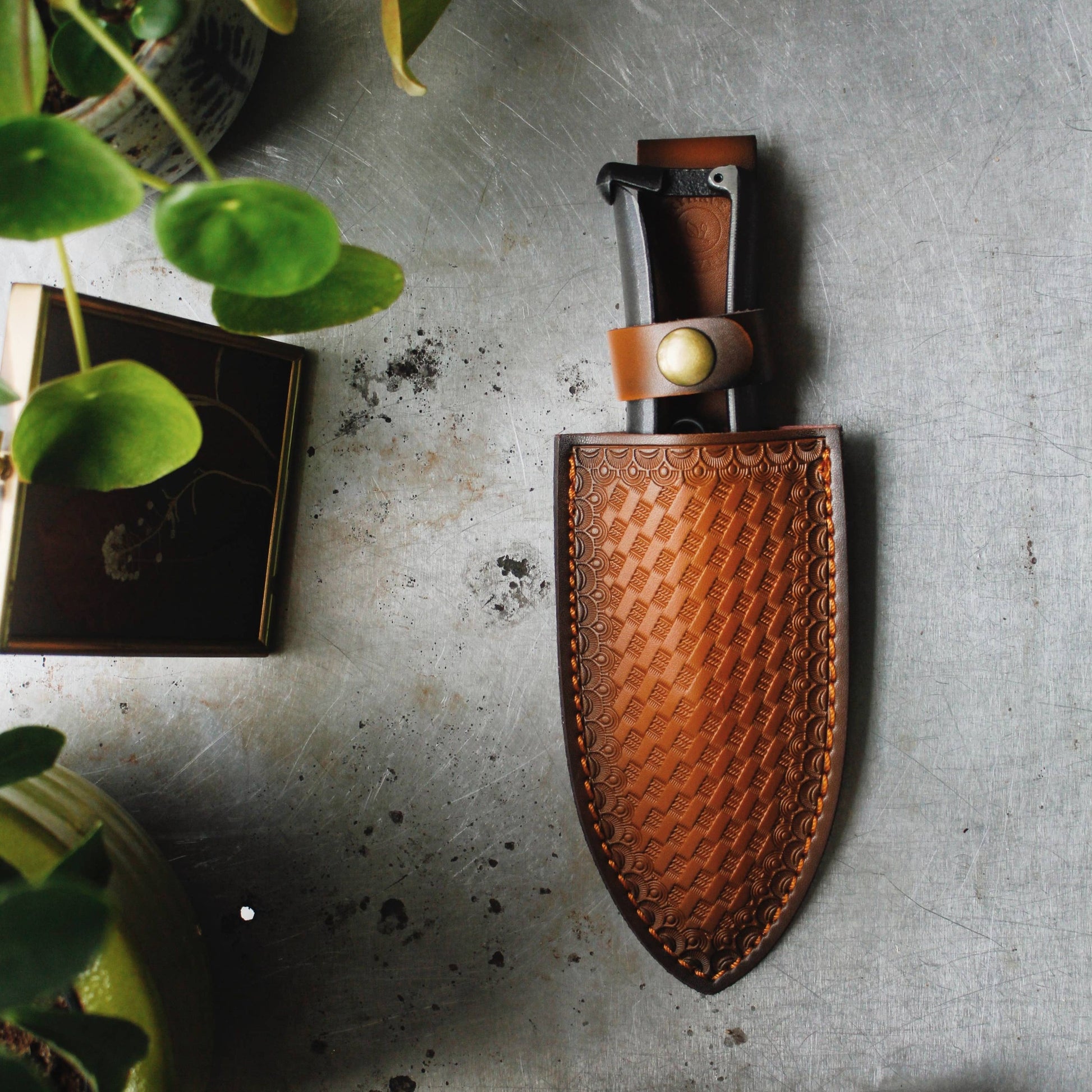 Japanese carbon steel gardening shears for pruning.  Bypass secateurs in a brown faux leather tooled case. Beautiful scalloped and cross hatched design and brass snap button closure