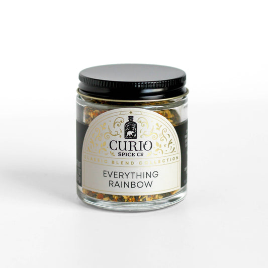 Colorful rainbow everything bagel seasoning by Curio Spice Co in a glass jar. Allium Free spice blend. 