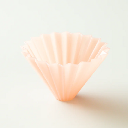 A pink resin cone-shaped coffee dripper.