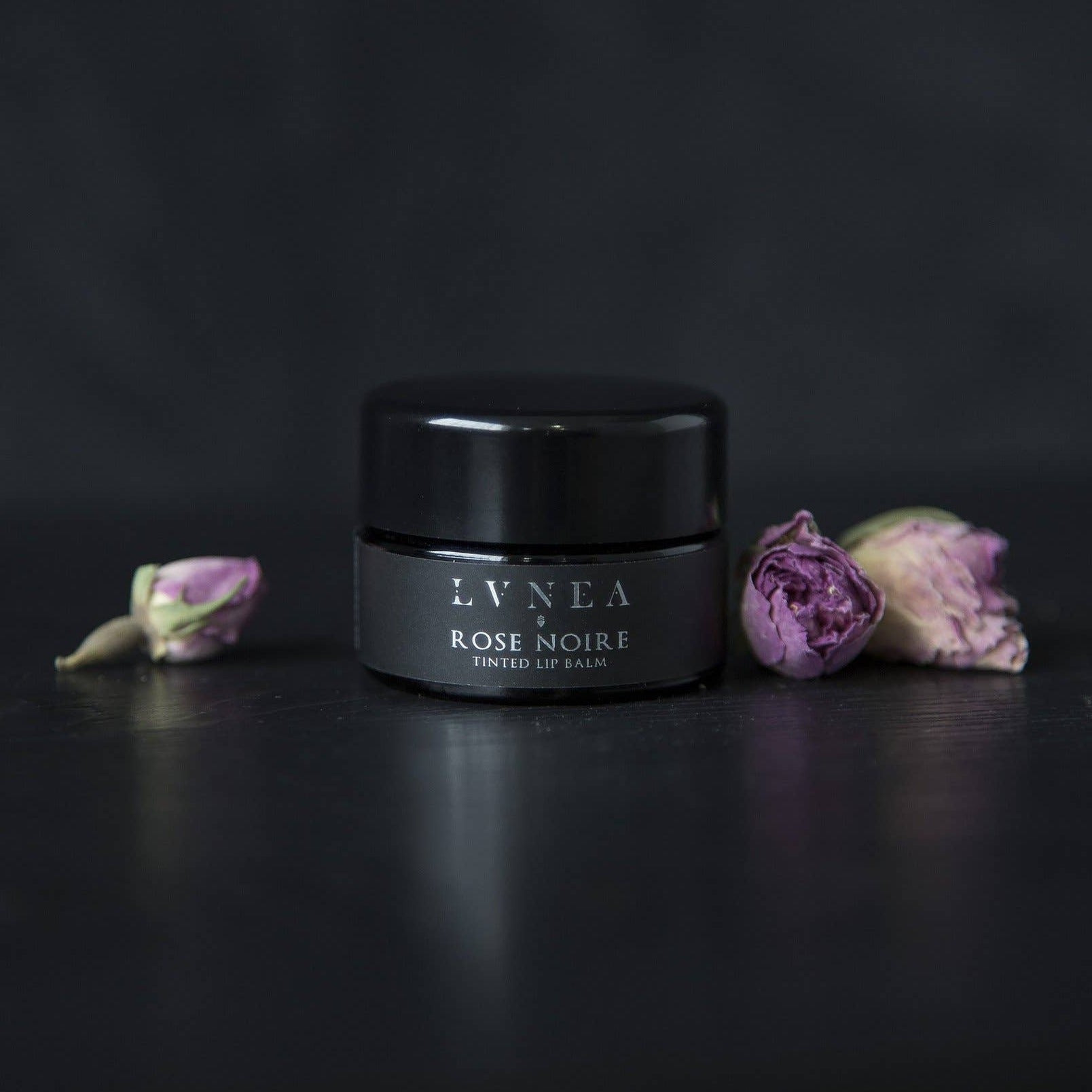 Rose Noire tinted lip balm by Lvnea in a black glass small jar. Rose scented tinted lip balm. 